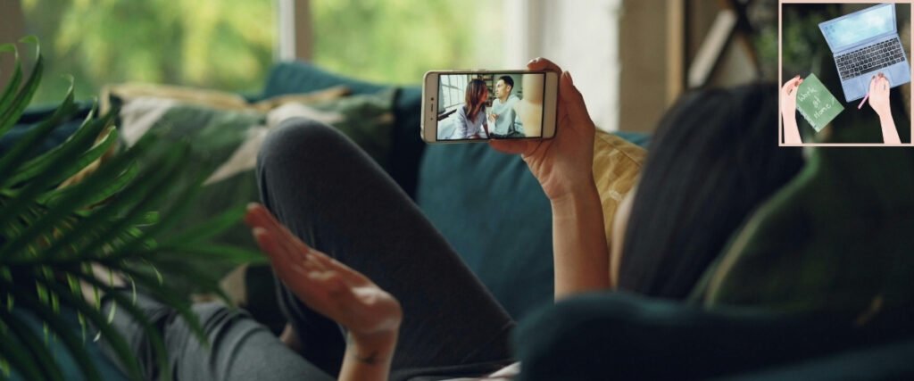 Person taking a video call on a smartphone while sitting on a sofa at home.